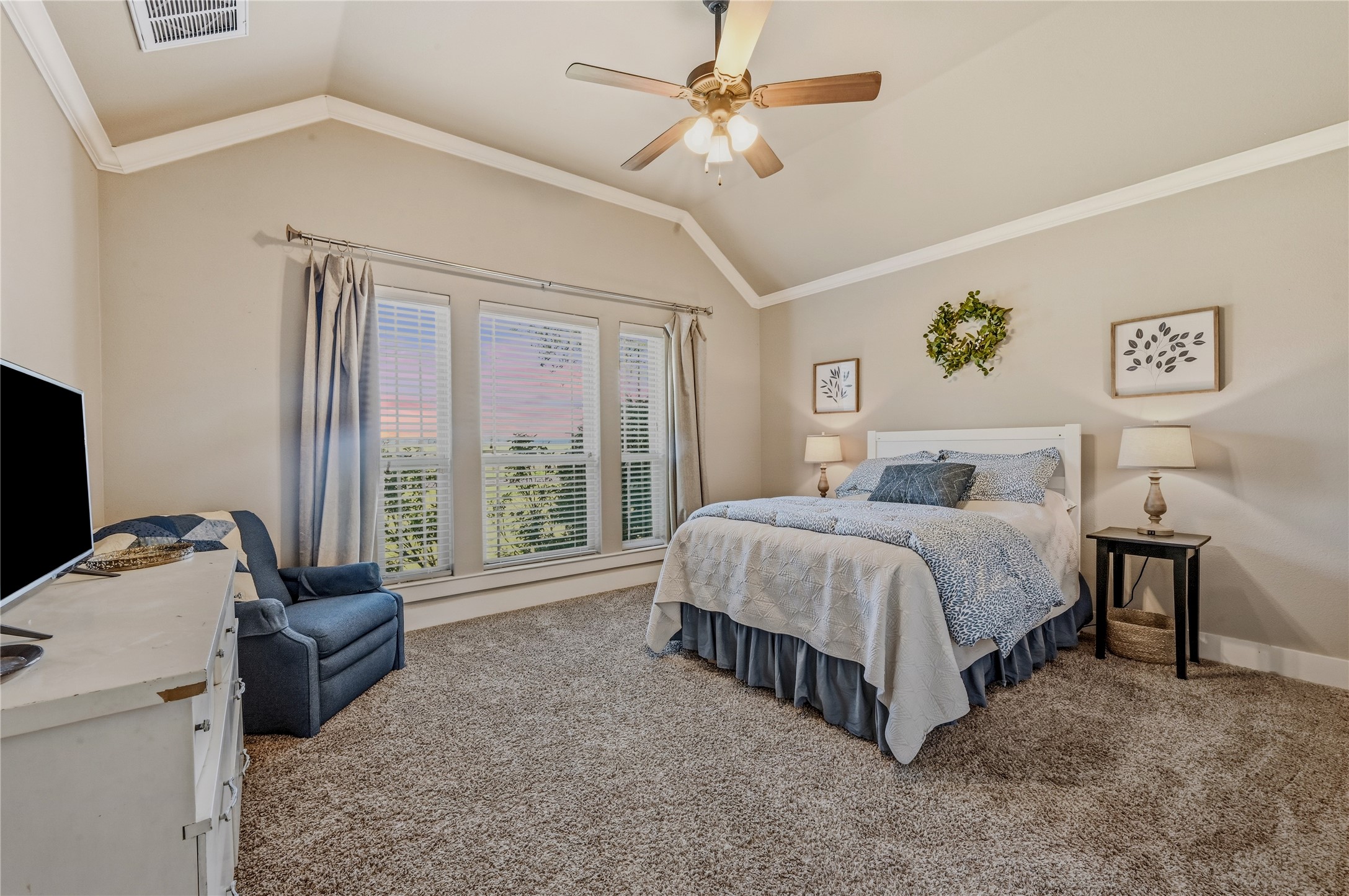4467 West Amity Road Salado, TX 76571 - Photo 24 of 40 This bedroom features vaulted ceilings, a ceiling fan with integrated lighting, and carpeted flooring