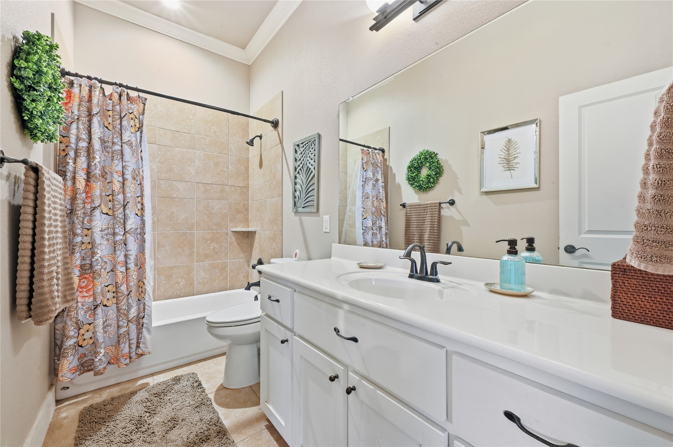4467 West Amity Road Salado, TX 76571 - Photo 26 of 40 Bathroom featuring a white vanity with a single sink and dark-toned faucet, a large mirror, and a bathtub with tiled surround