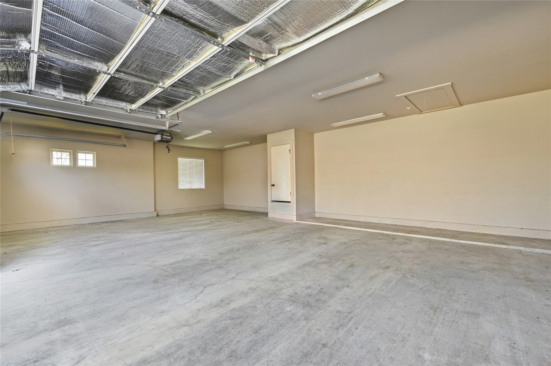 4467 West Amity Road Salado, TX 76571 - Photo 29 of 40 Spacious garage featuring a concrete floor, light-colored walls, and overhead lighting