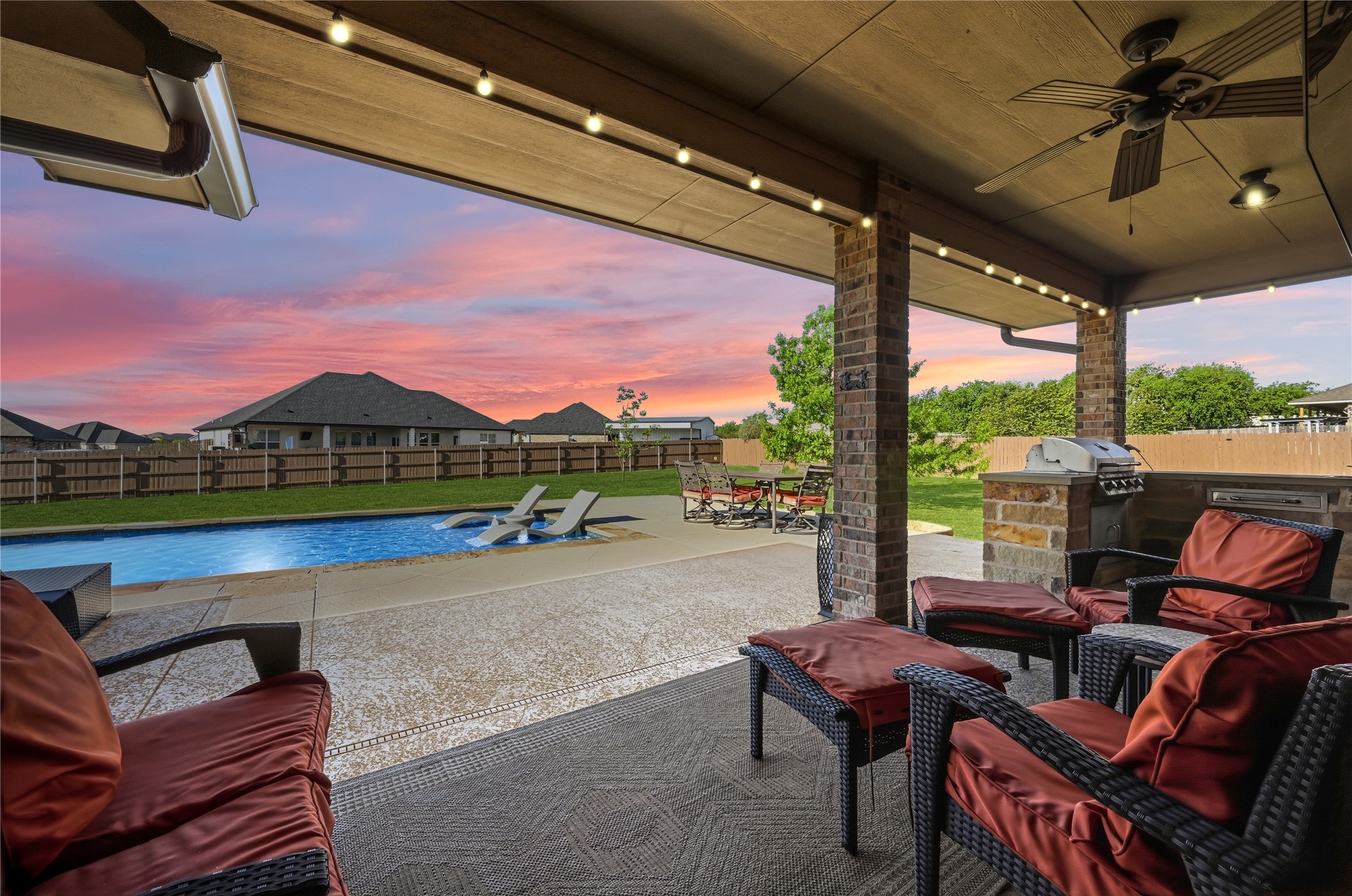 4467 West Amity Road Salado, TX 76571 - Photo 31 of 40 Expansive covered patio featuring string lights, a ceiling fan, and an outdoor kitchen with a built-in grill