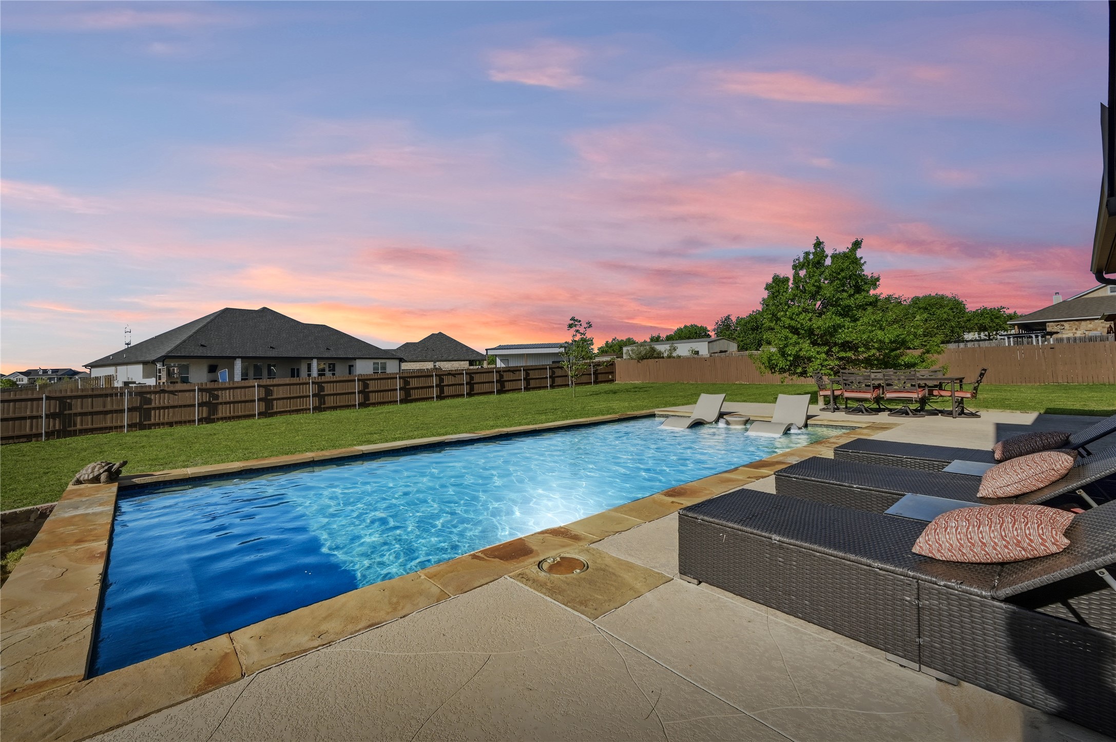 4467 West Amity Road Salado, TX 76571 - Photo 33 of 40 The property features an extensive backyard with a rectangular swimming pool, surrounded by a concrete patio and natural stone coping