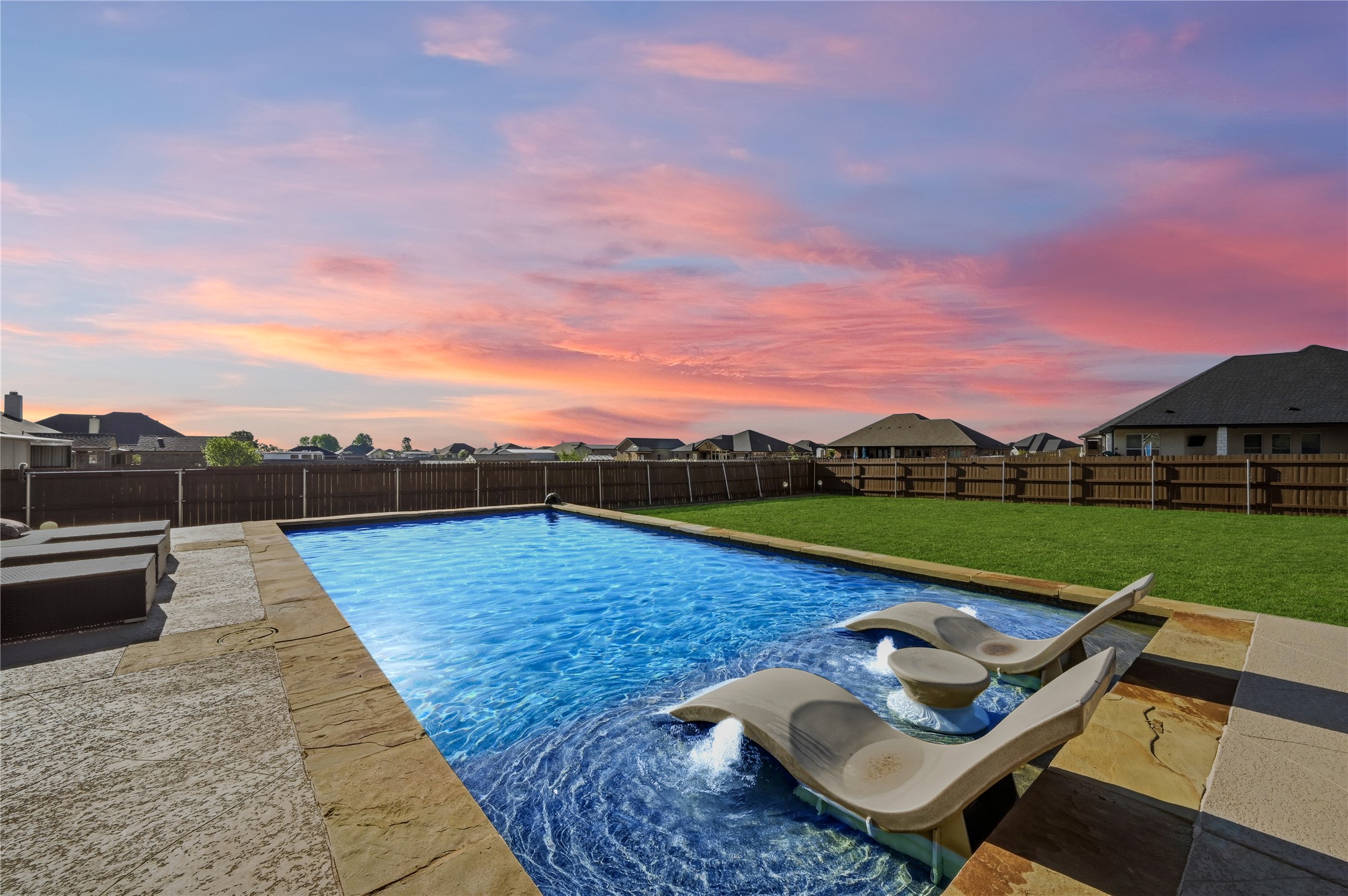 4467 West Amity Road Salado, TX 76571 - Photo 35 of 40 The property features a rectangular swimming pool with integrated lounge chairs and a perimeter of stone coping