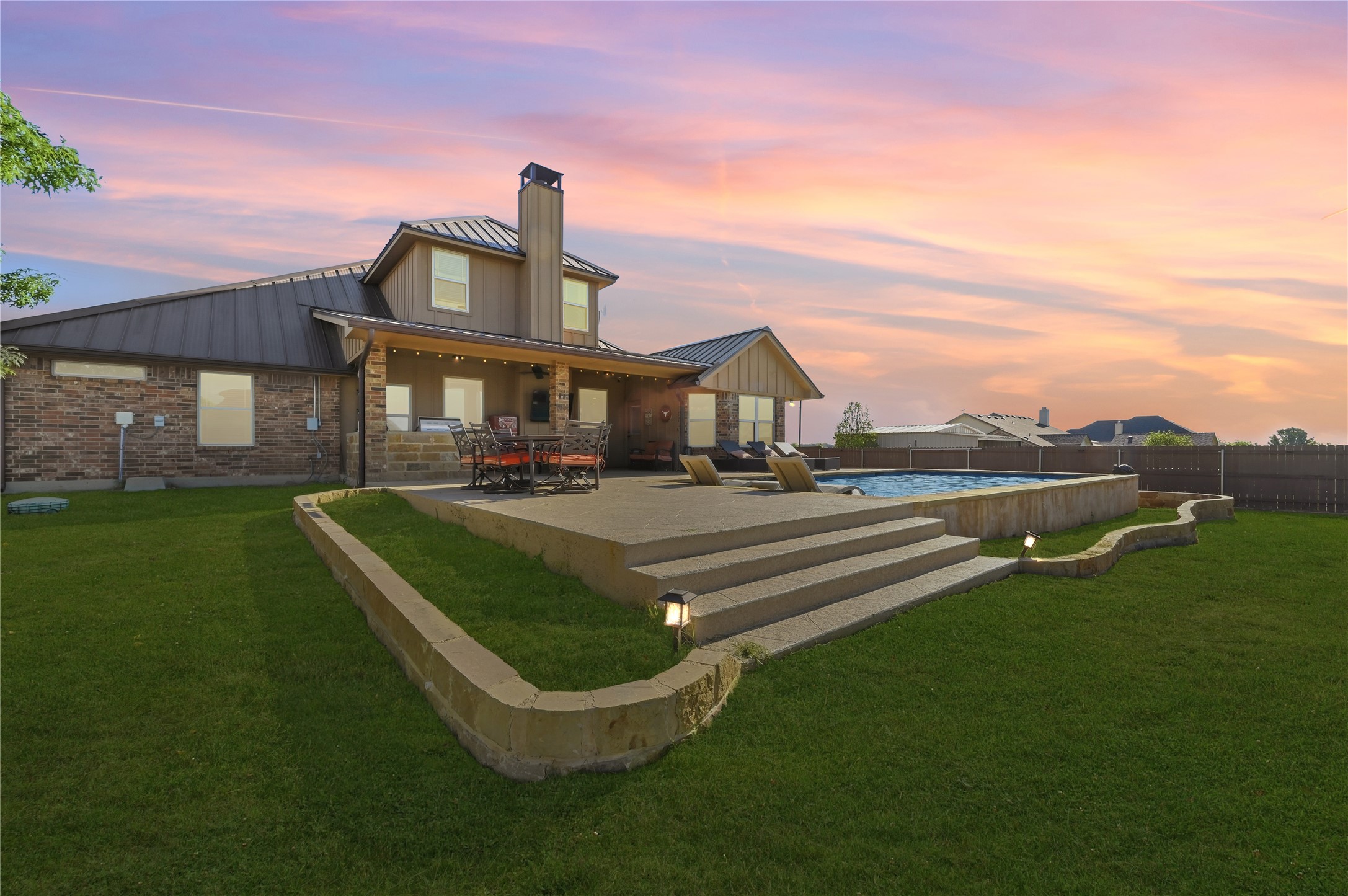 4467 West Amity Road Salado, TX 76571 - Photo 38 of 40 The property features an expansive lawn, a patio area with an outdoor dining set, and an outdoor swimming pool