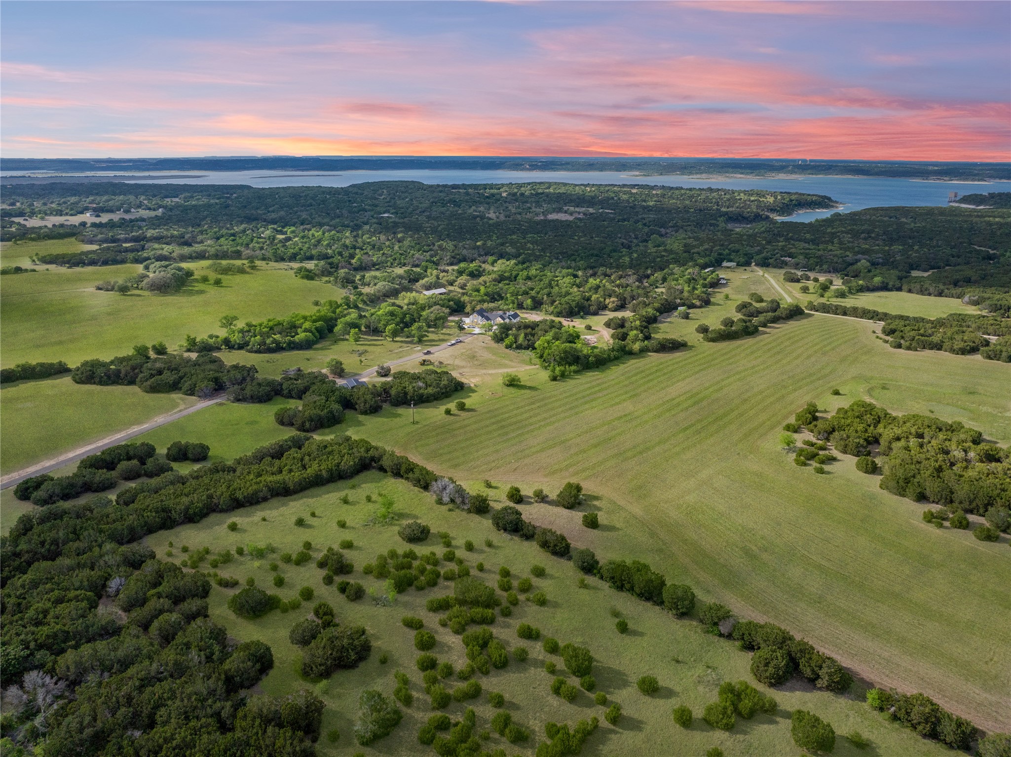 4467 West Amity Road Salado, TX 76571 - Photo 40 of 40 Expansive property featuring verdant fields, clusters of trees, and a distant body of water under a vibrant sky