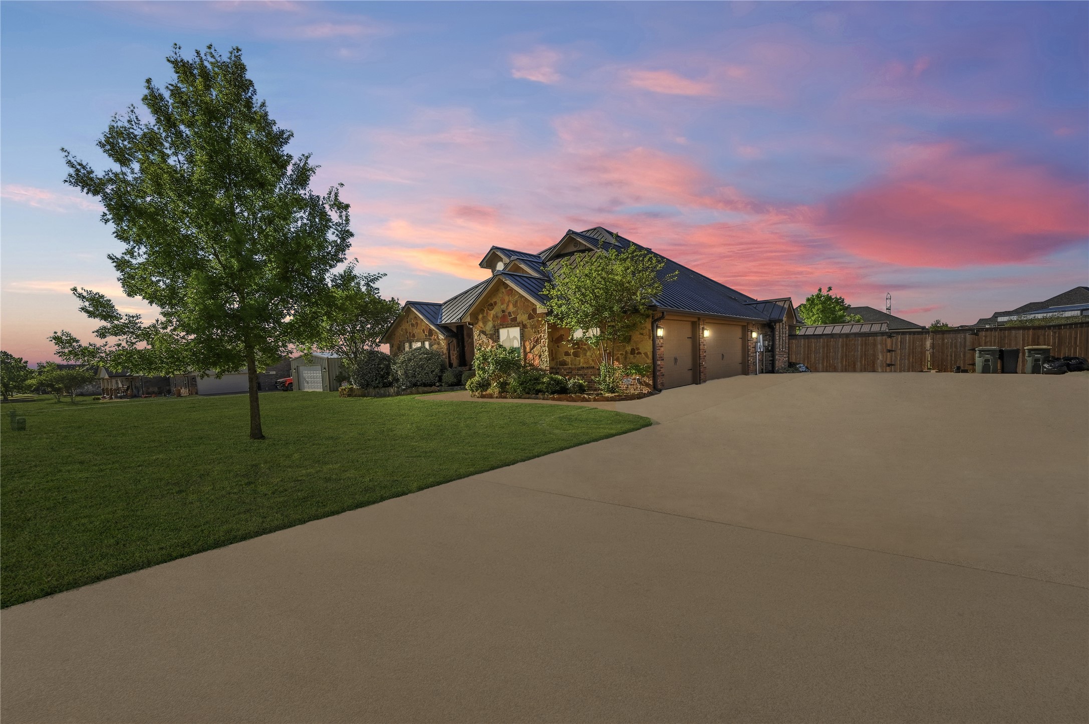 4467 West Amity Road Salado, TX 76571 - Photo 4 of 40 The property features a stone facade, a paved driveway, and an expansive lawn with mature trees