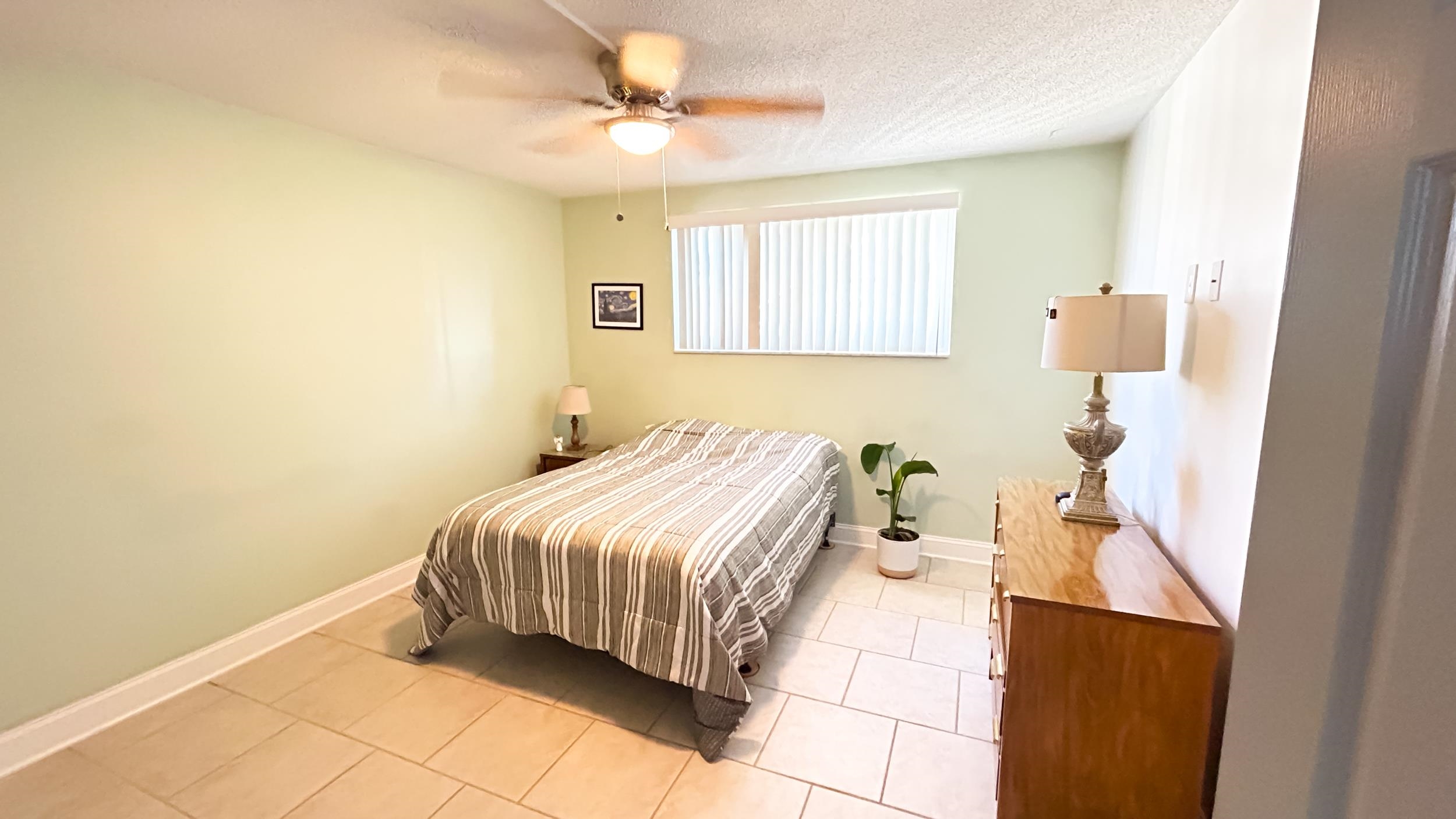 320 3rd Street North Flagler Beach, FL 32136 - Photo 19 of 29 a bedroom with a bed and a chandelier