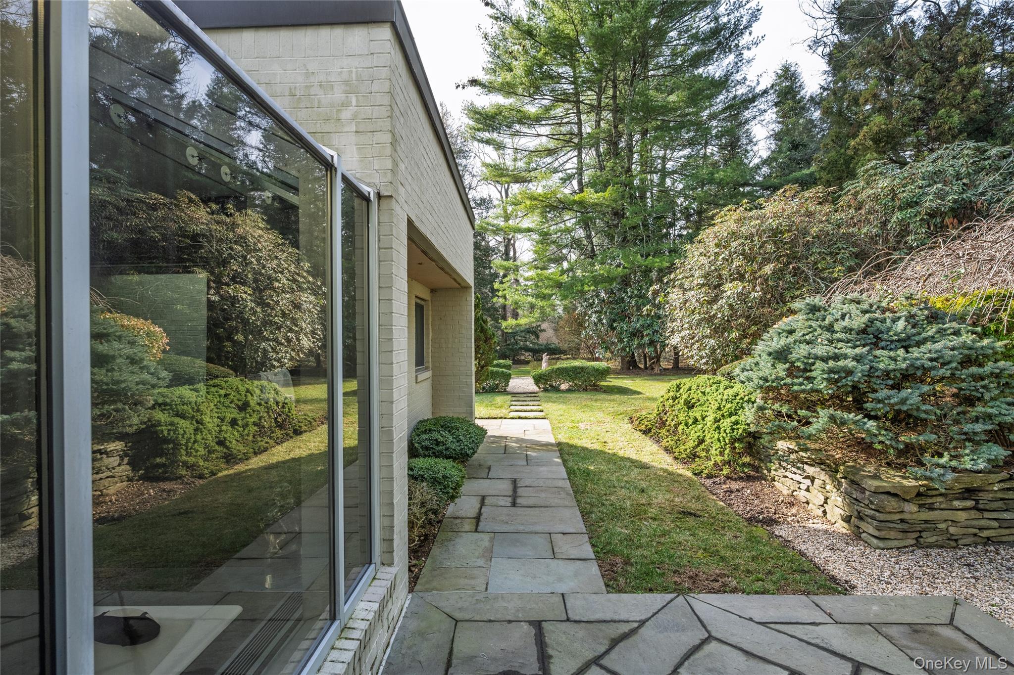 120 Bacon Road Old Westbury, NY 11568 - Photo 26 of 29 a front view of a house with a yard