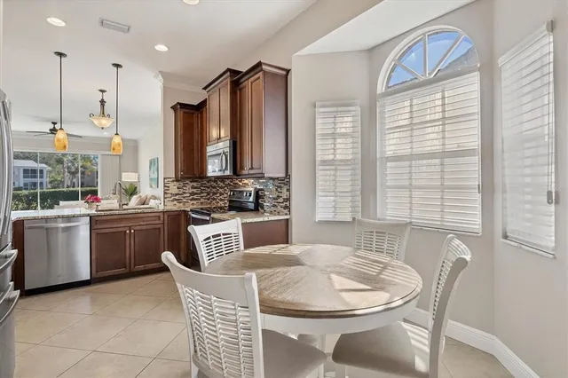 a kitchen with a table chairs sink and cabinets