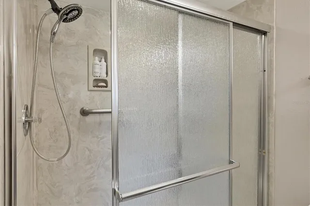 a bathroom with a glass shower door