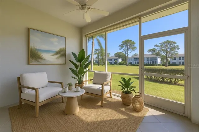 a living room with furniture and a potted plant