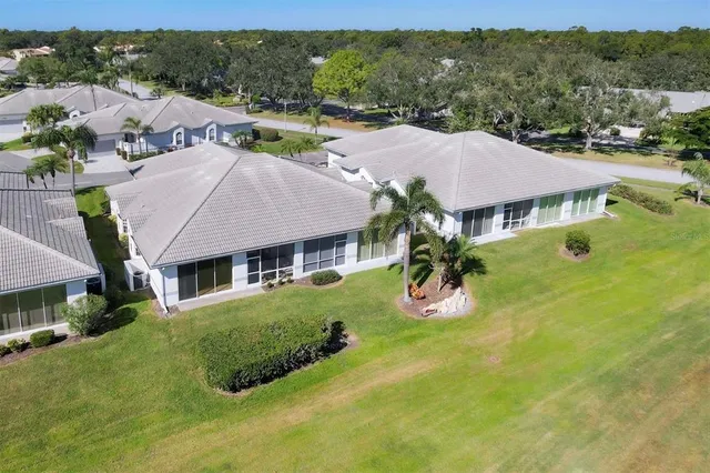an aerial view of residential houses with outdoor space