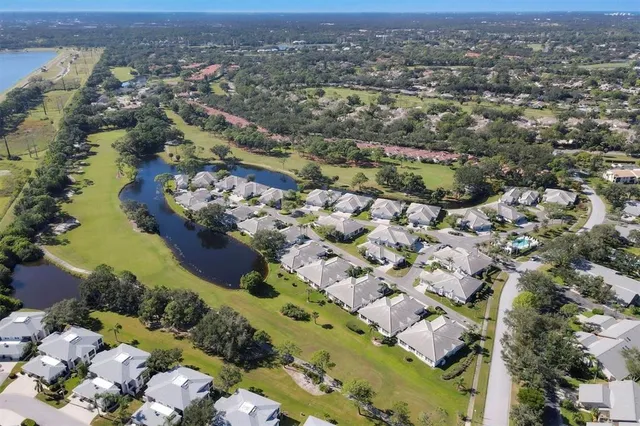 a view of a street with a cars parked and small park