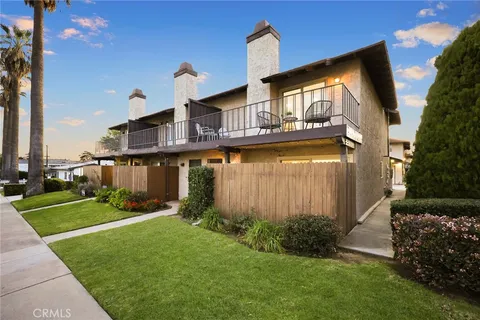 a backyard of a house with a garden and barbeque oven