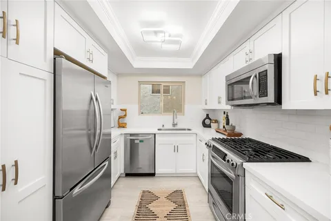 a kitchen with a refrigerator stove and microwave