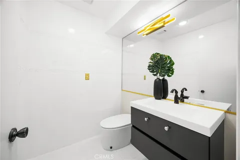 a bathroom with a sink toilet and mirror