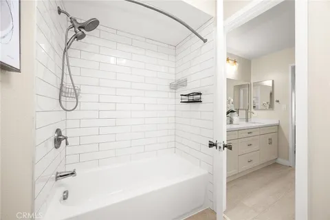 a bathroom with a bathtub a sink a vanity and a shower