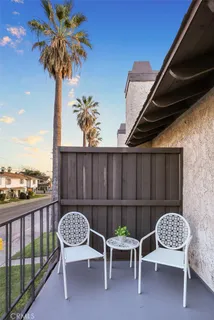 a view of a chairs and table in the balcony