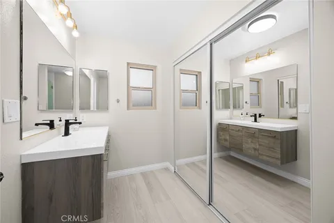 a bathroom with a double vanity sink mirror and