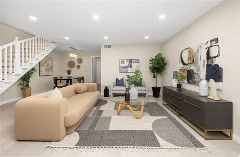 a living room with furniture and wooden floor