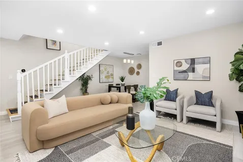 a living room with furniture and a potted plant