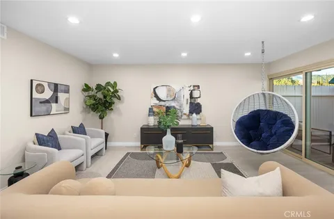 a living room with furniture a rug and white walls