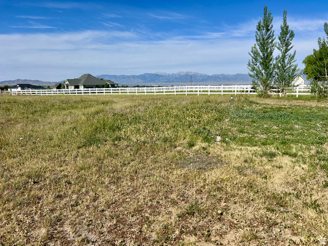 812 East Bates Cyn Road Tooele, UT 84074 - Photo 117 of 144 Expansive open land featuring a white fence line and distant mountain range