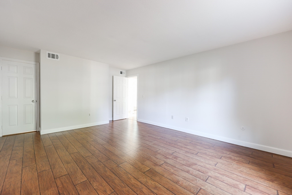 14 Shadowbrook Lane, Unit 30 Milford, MA 01757 - Photo 11 of 18 a view of an empty room and wooden floor