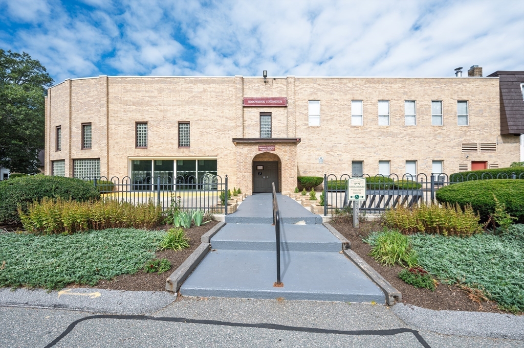 14 Shadowbrook Lane, Unit 30 Milford, MA 01757 - Photo 16 of 18 a front view of a building with garden