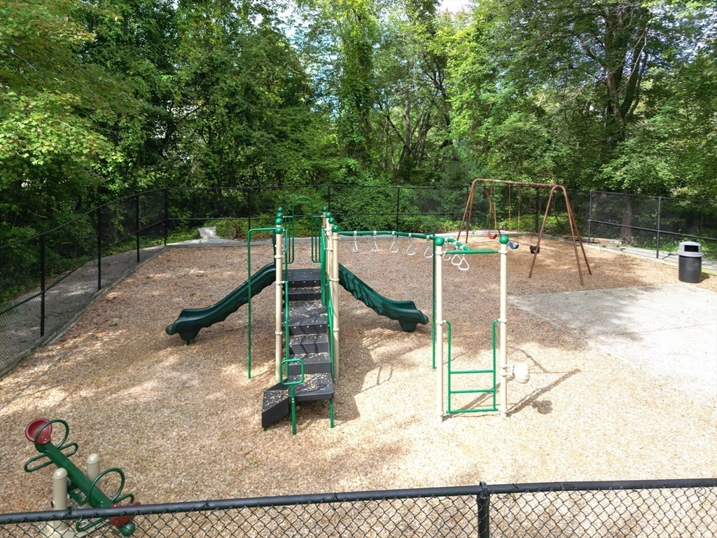 14 Shadowbrook Lane, Unit 30 Milford, MA 01757 - Photo 17 of 18 a backyard of a house with table and chairs