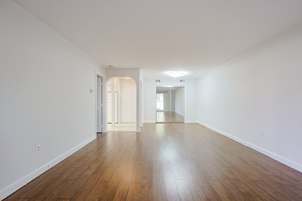 14 Shadowbrook Lane, Unit 30 Milford, MA 01757 - Photo 4 of 18 a view of an empty room and wooden floor