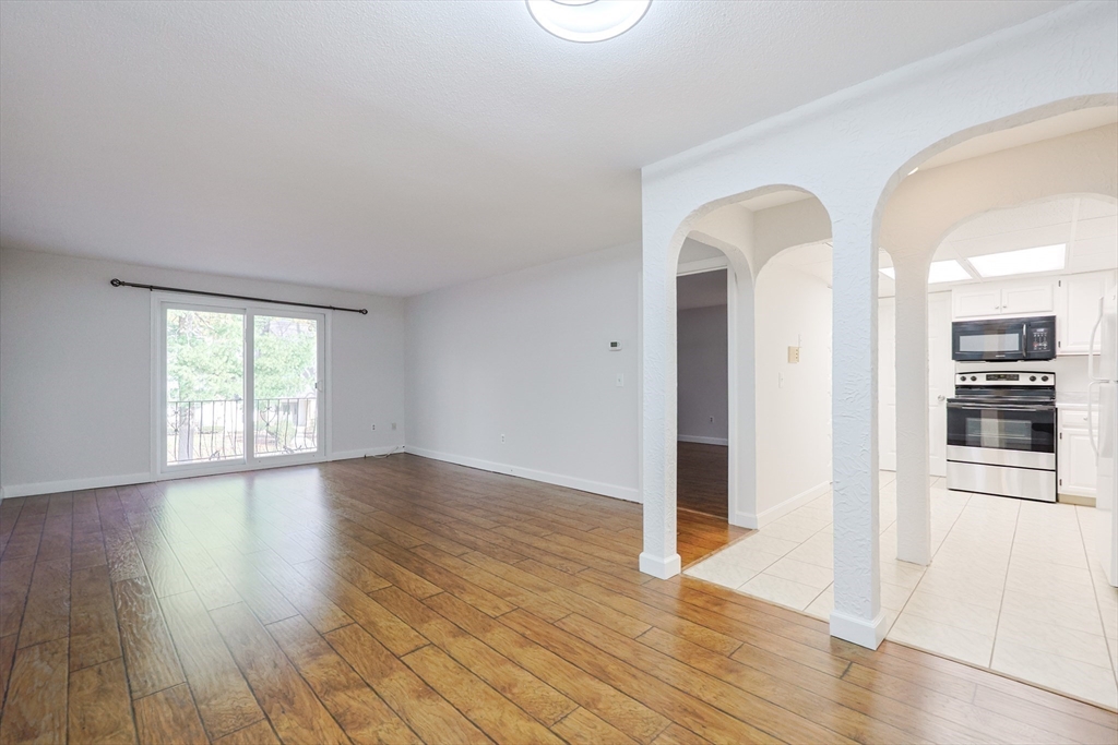 14 Shadowbrook Lane, Unit 30 Milford, MA 01757 - Photo 5 of 18 an empty room with wooden floor and windows