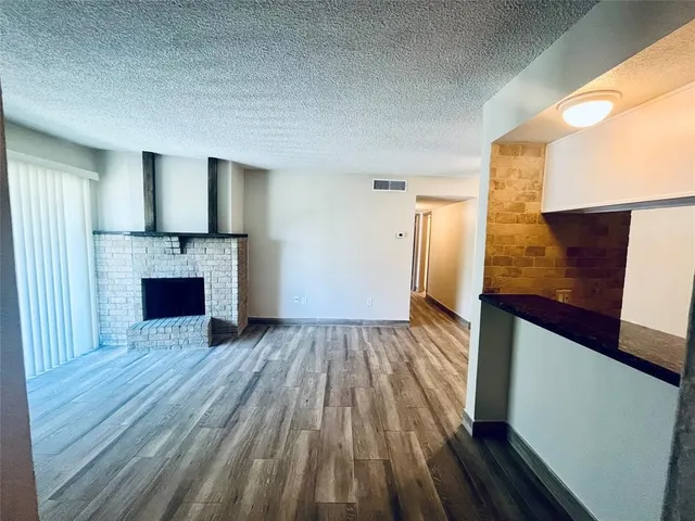 a view of kitchen and hallway with wooden floor