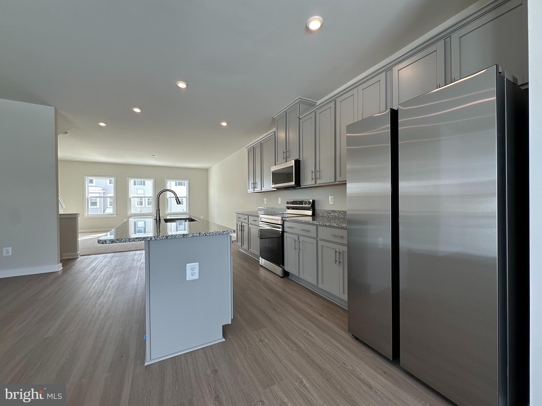 69 Trotting Road Inwood, WV 25428 - Photo 15 of 43 a kitchen with a refrigerator a sink dishwasher with a stove and wooden floor