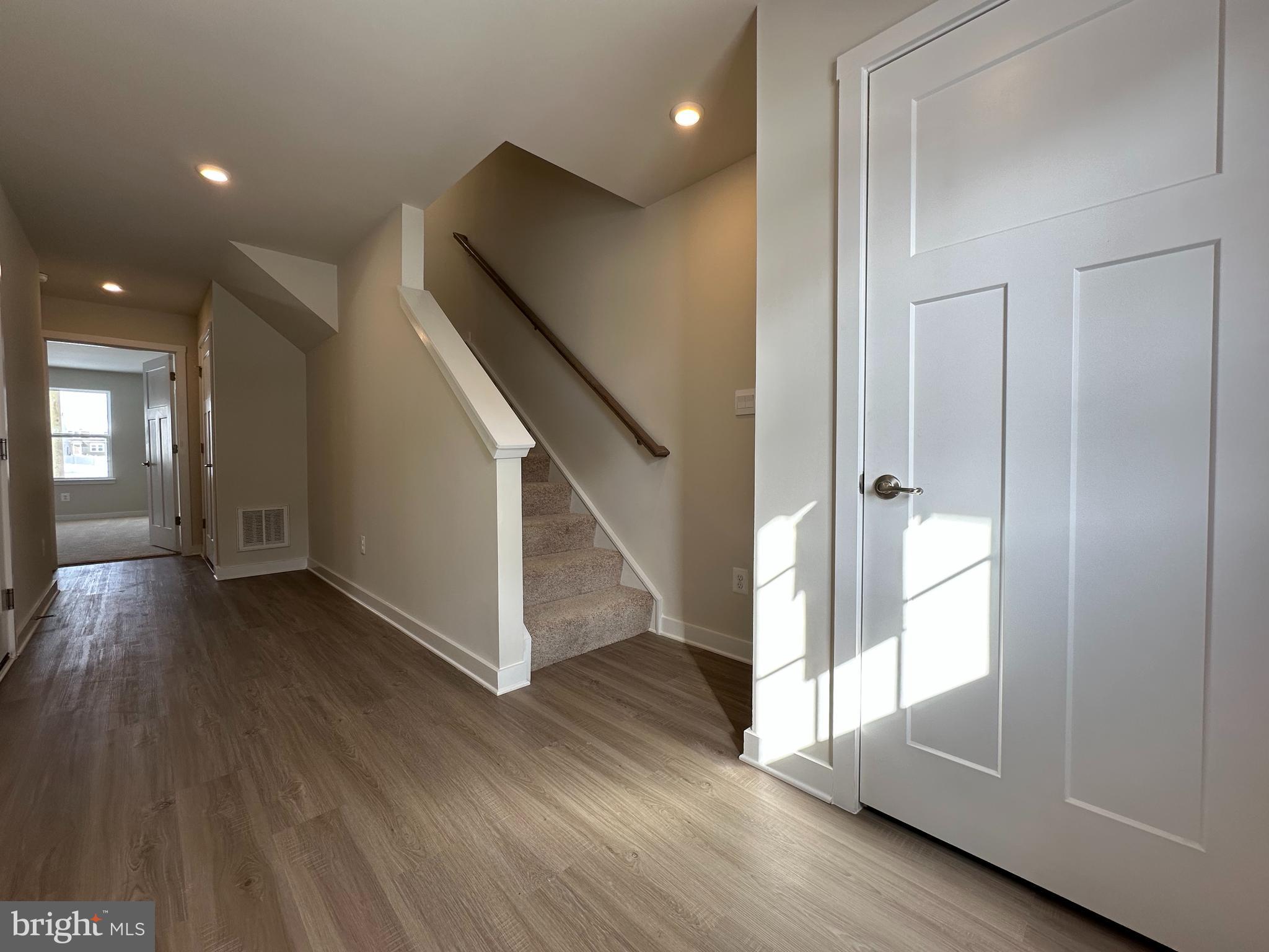 69 Trotting Road Inwood, WV 25428 - Photo 3 of 43 a view of a hallway with wooden floor and staircase