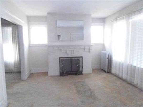 53 Calumet Road Holyoke, MA 01040 - Photo 6 of 12 an empty room with windows and fireplace