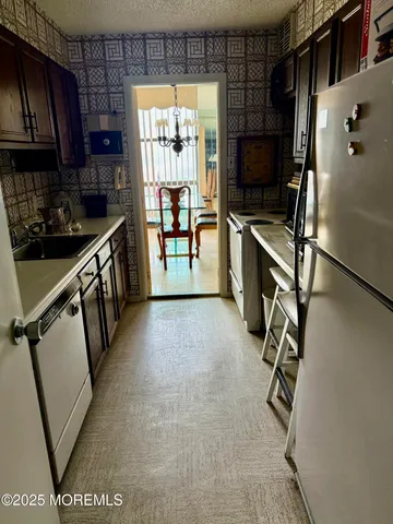 a kitchen with stainless steel appliances a refrigerator and a sink