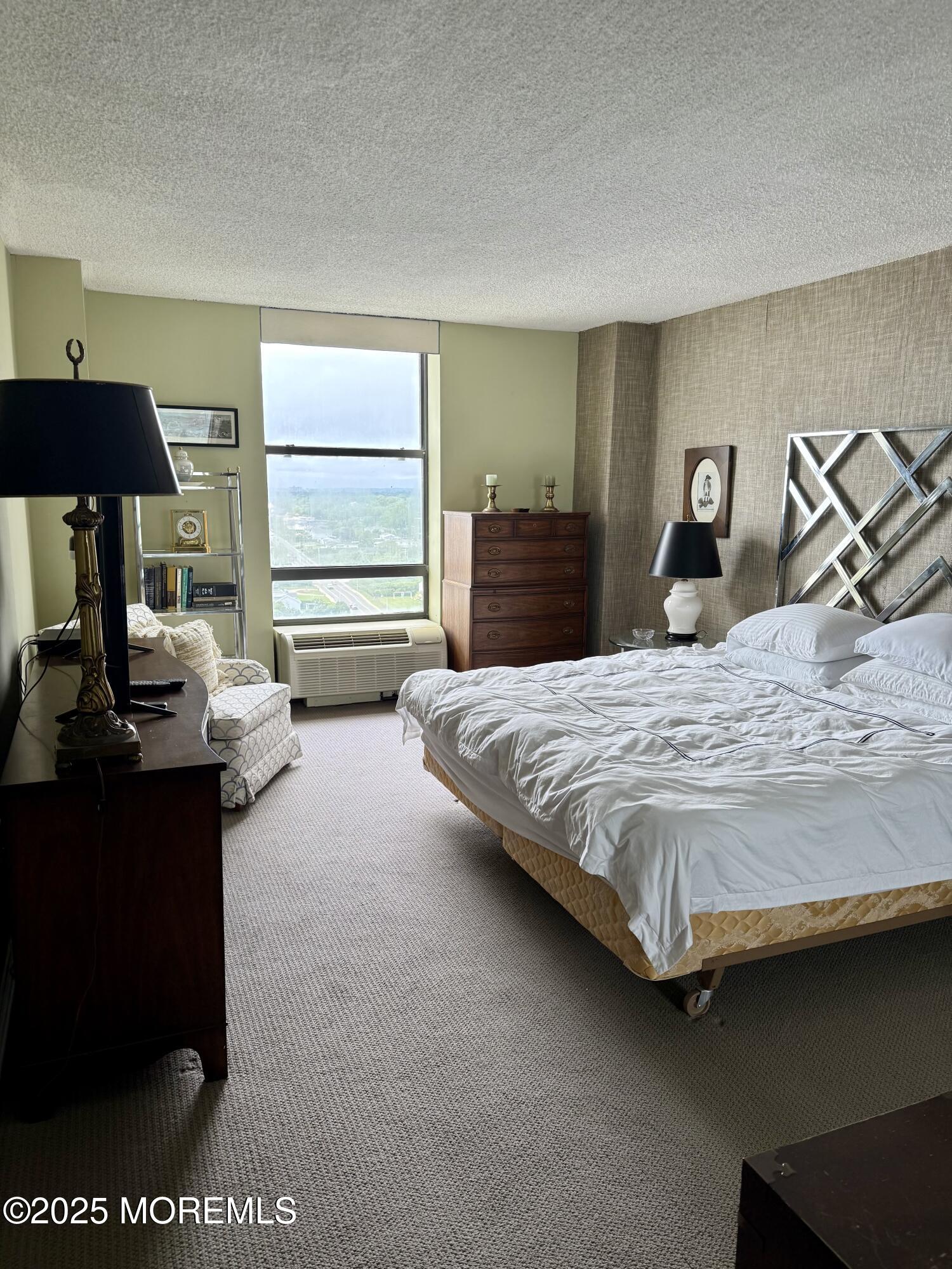 787 Ocean Avenue, Unit 1906 Long Branch, NJ 07740 - Photo 4 of 7 a bedroom with a bed and dresser next to a window