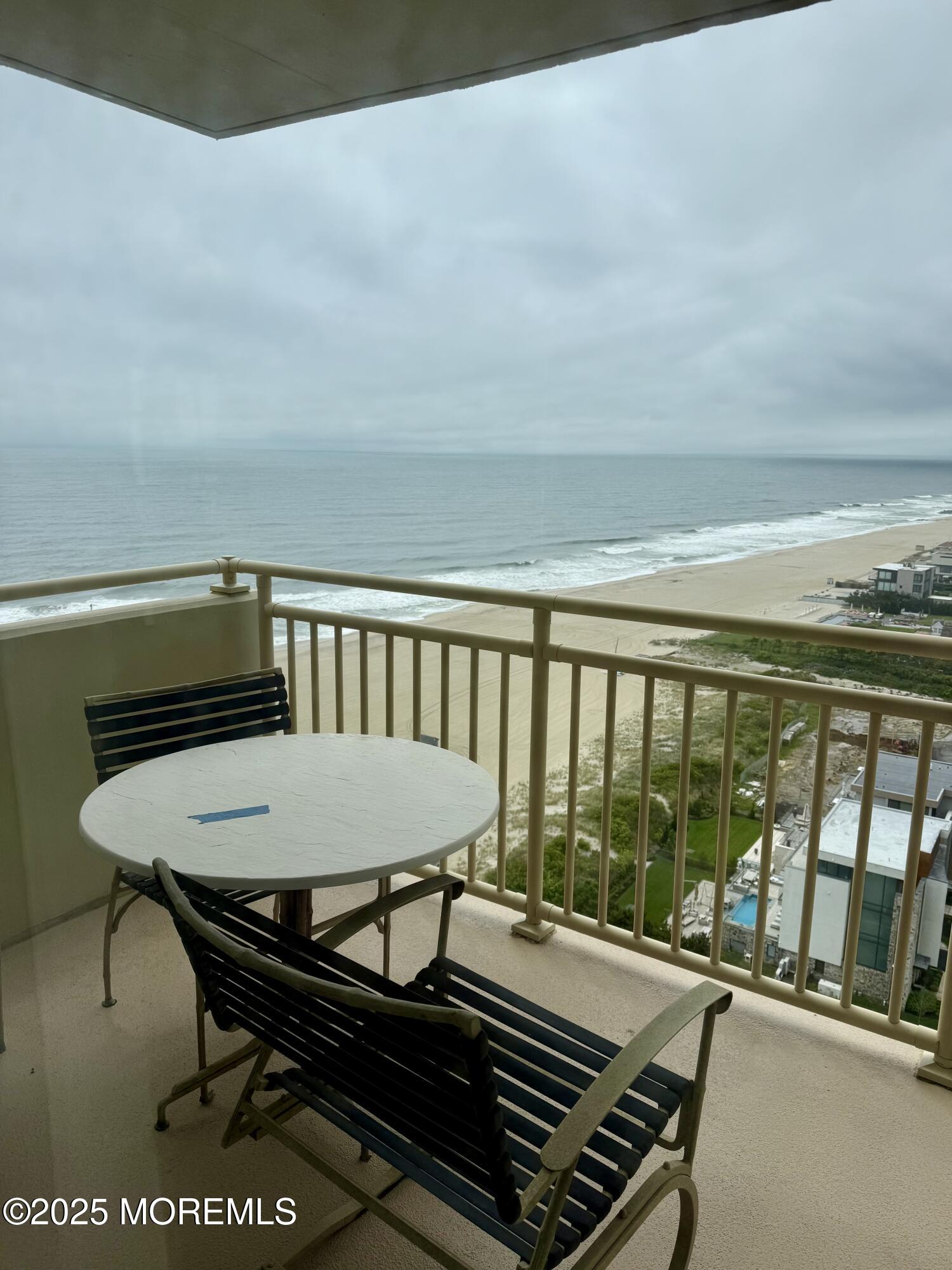 787 Ocean Avenue, Unit 1906 Long Branch, NJ 07740 - Photo 6 of 7 a balcony with table and chairs
