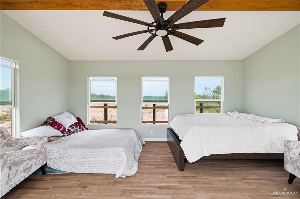 0 Out Of Area Roma, TX 78584 - Photo 13 of 23 a bedroom with a large bed and a chandelier