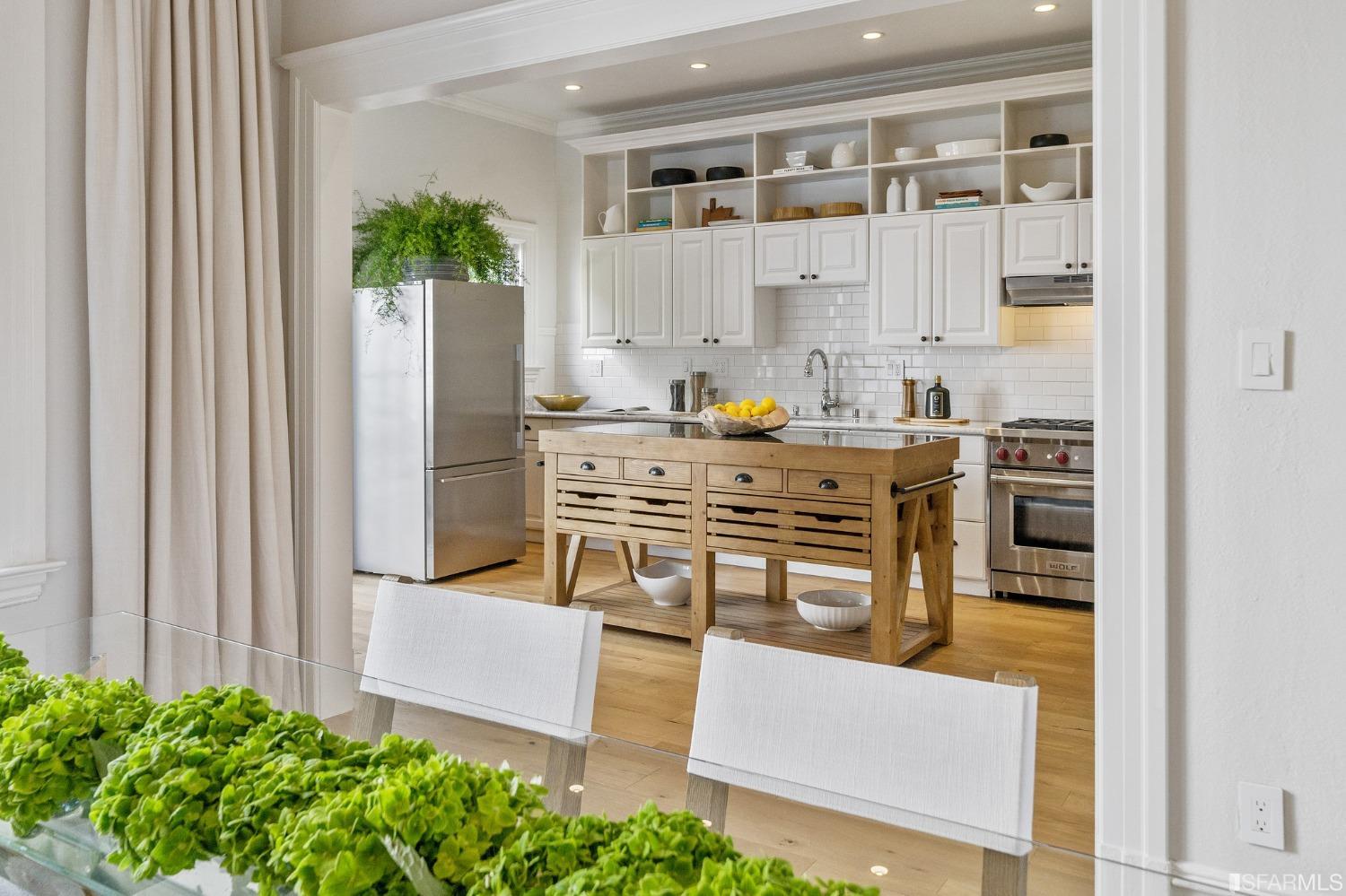 104 3rd Avenue San Francisco, CA 94118 - Photo 11 of 41 a kitchen with stainless steel appliances a stove a chimney a sink and cabinets