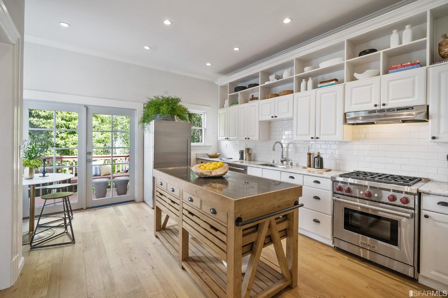 104 3rd Avenue San Francisco, CA 94118 - Photo 12 of 41 a kitchen with stainless steel appliances granite countertop a stove oven and a refrigerator with wooden floor