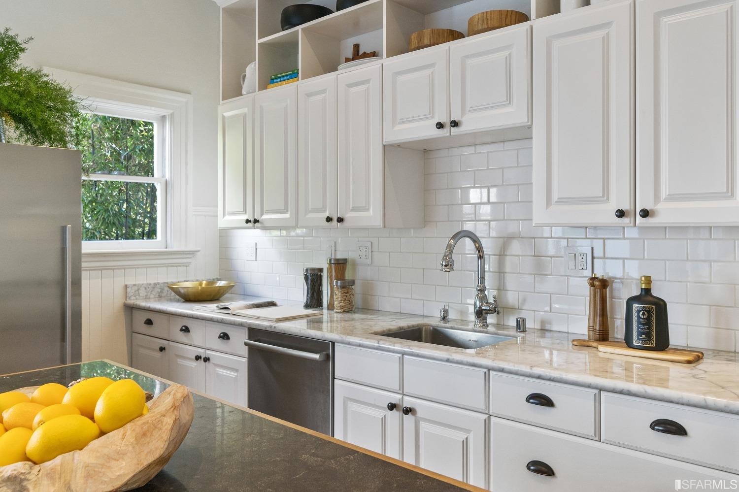 104 3rd Avenue San Francisco, CA 94118 - Photo 13 of 41 a kitchen with stainless steel appliances granite countertop a sink a stove and a white cabinets