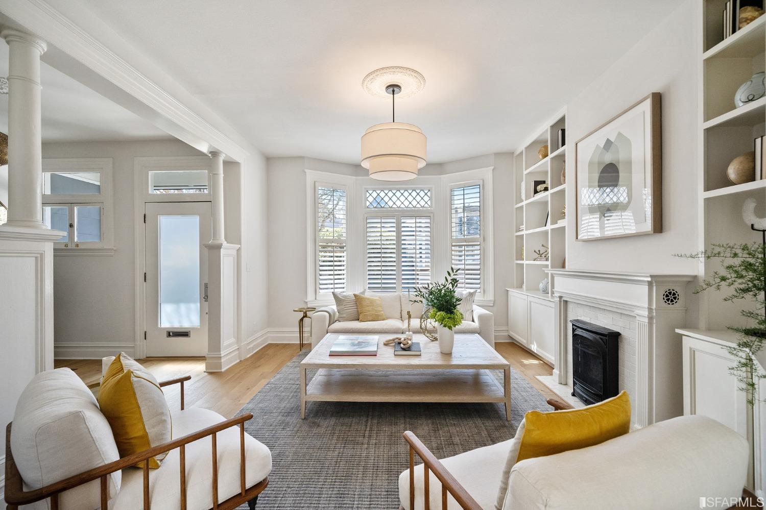 104 3rd Avenue San Francisco, CA 94118 - Photo 3 of 41 a living room with furniture a fireplace and a chandelier