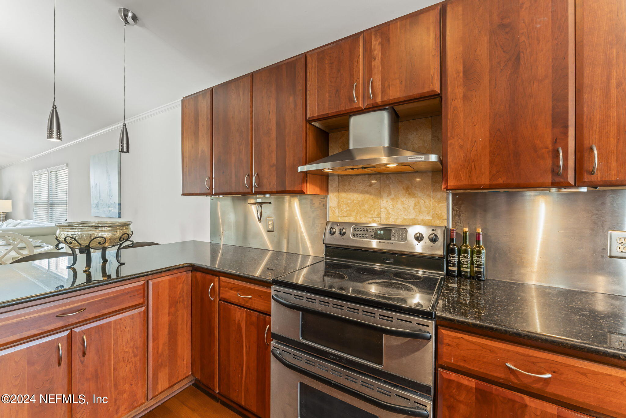 256 Patrick Mill Circle Ponte Vedra Beach, FL 32082 - Photo 14 of 69 a kitchen with granite countertop wood cabinets stainless steel appliances and a sink