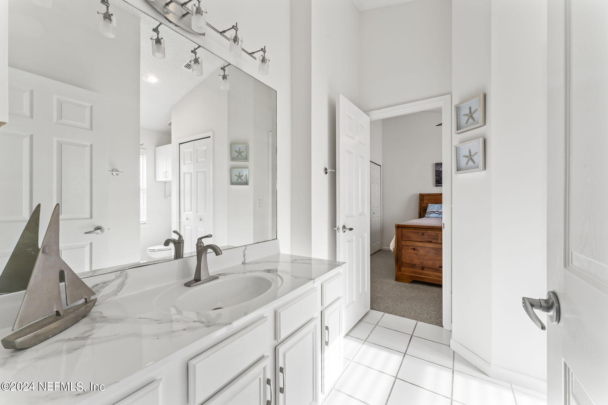 256 Patrick Mill Circle Ponte Vedra Beach, FL 32082 - Photo 27 of 69 a bathroom with a double vanity sink a mirror and a bathtub