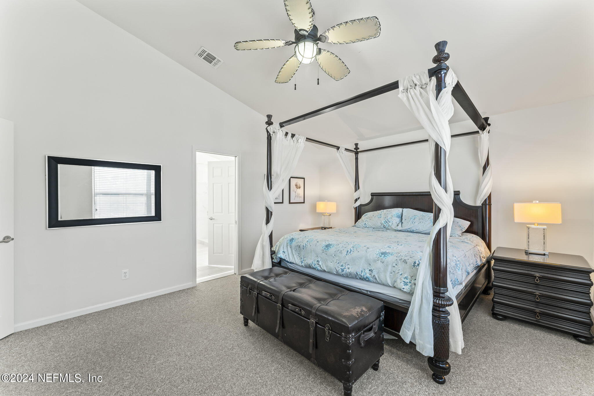 256 Patrick Mill Circle Ponte Vedra Beach, FL 32082 - Photo 38 of 69 a bedroom with a bed a chandelier and closet