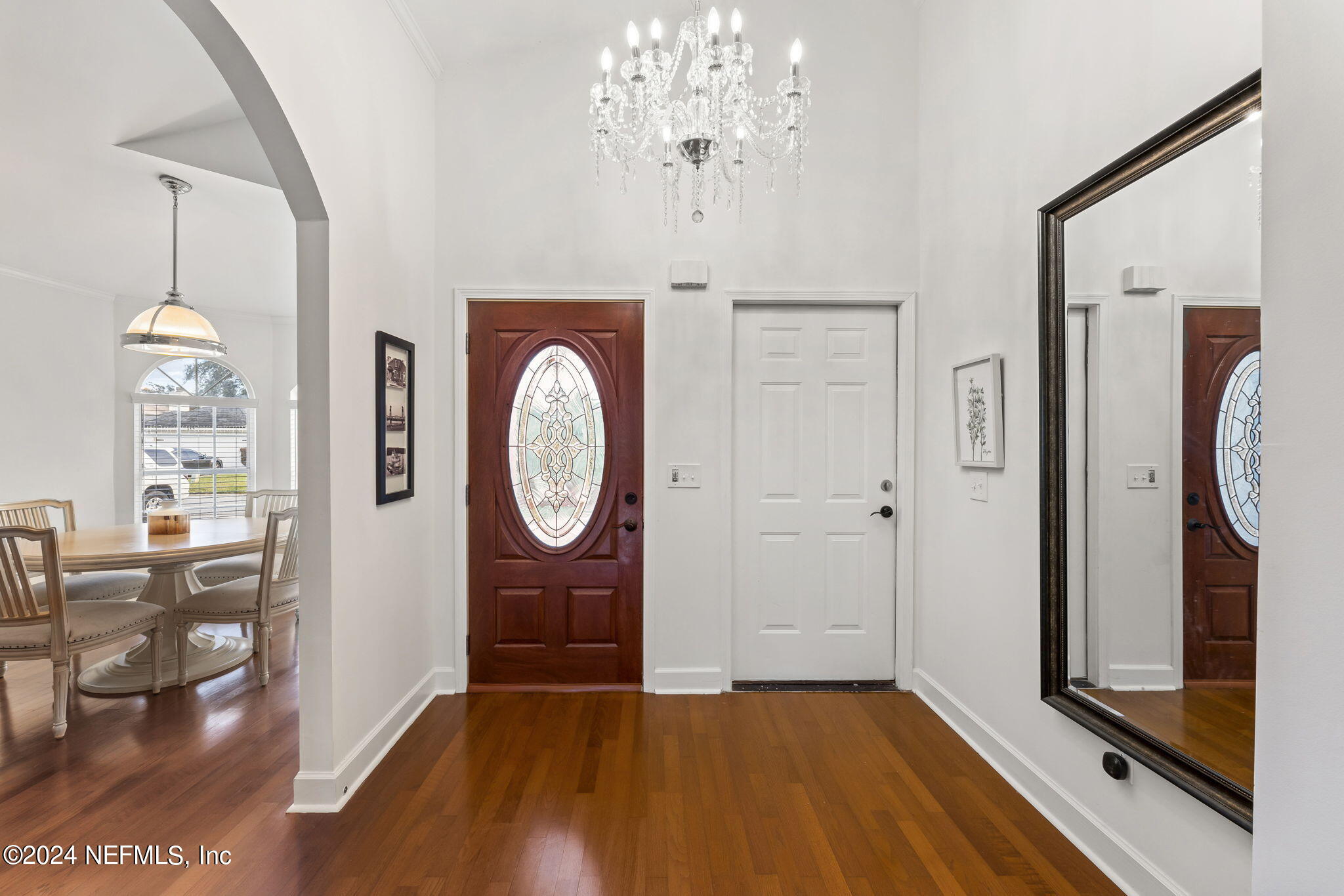 256 Patrick Mill Circle Ponte Vedra Beach, FL 32082 - Photo 8 of 69 a view of a hallway with wooden floor windows and a kitchen view