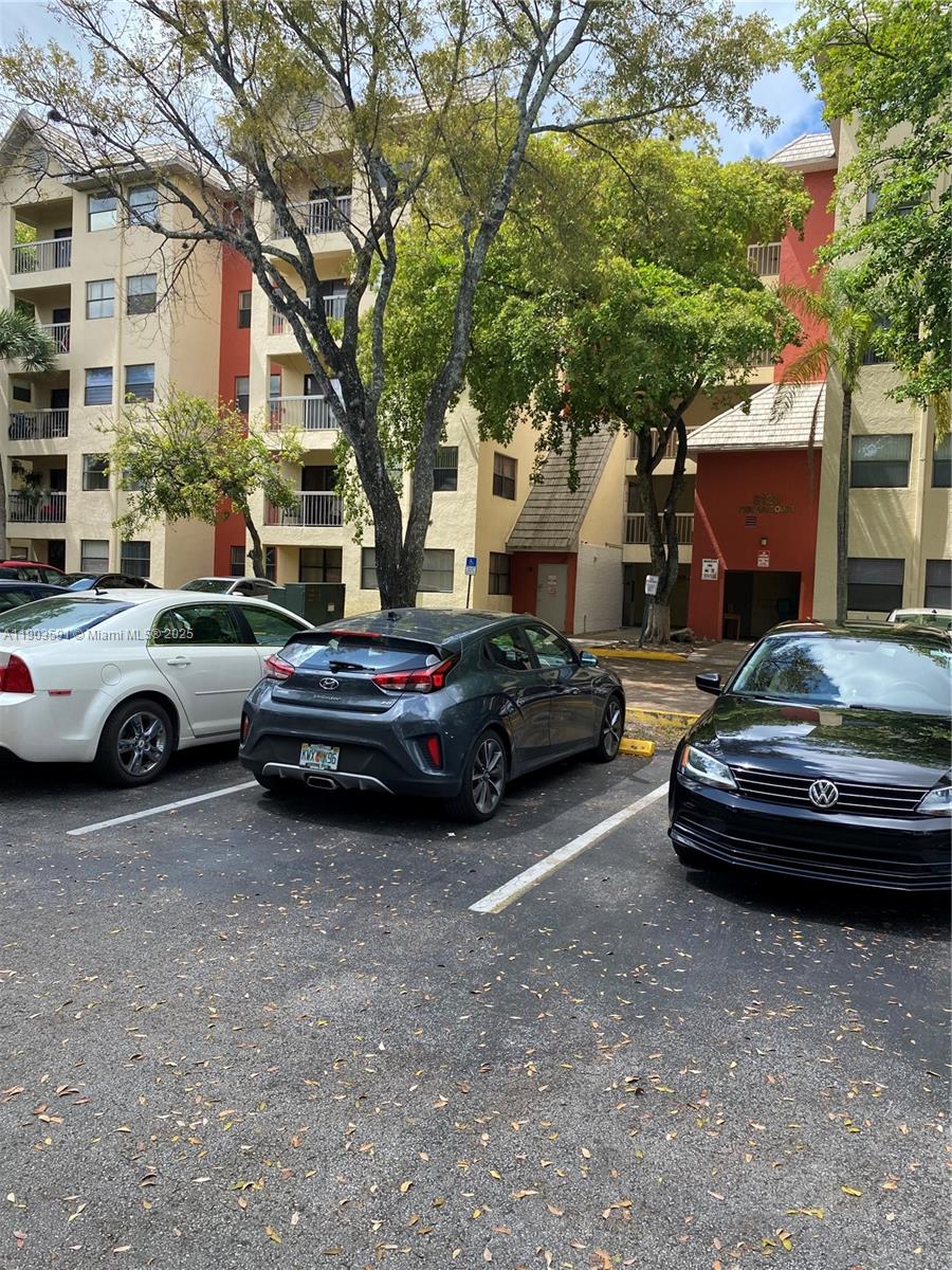 a view of a cars park in front of a building