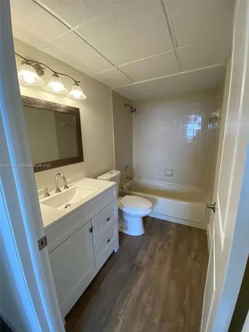 a bathroom with a double vanity sink toilet and mirror