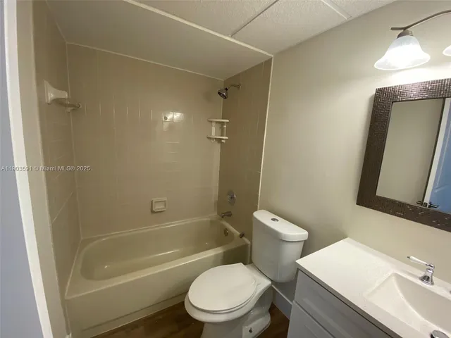 a bathroom with a toilet a sink and bathtub